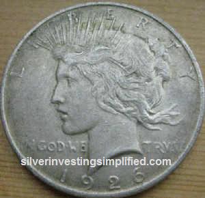 Peace silver dollar prior to cleaning.